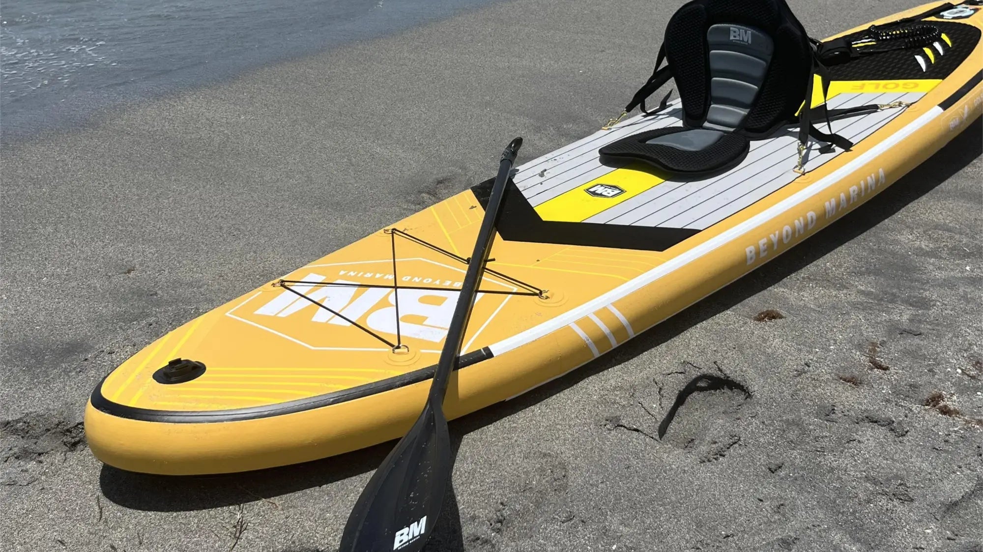 Yellow stand-up paddleboard with seat and paddle for water adventures, shown in SUP care article