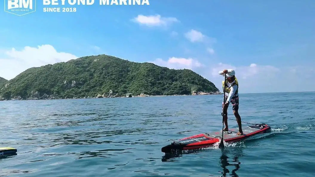 Person paddleboarding on an inflatable paddle board at Marina Race Uno