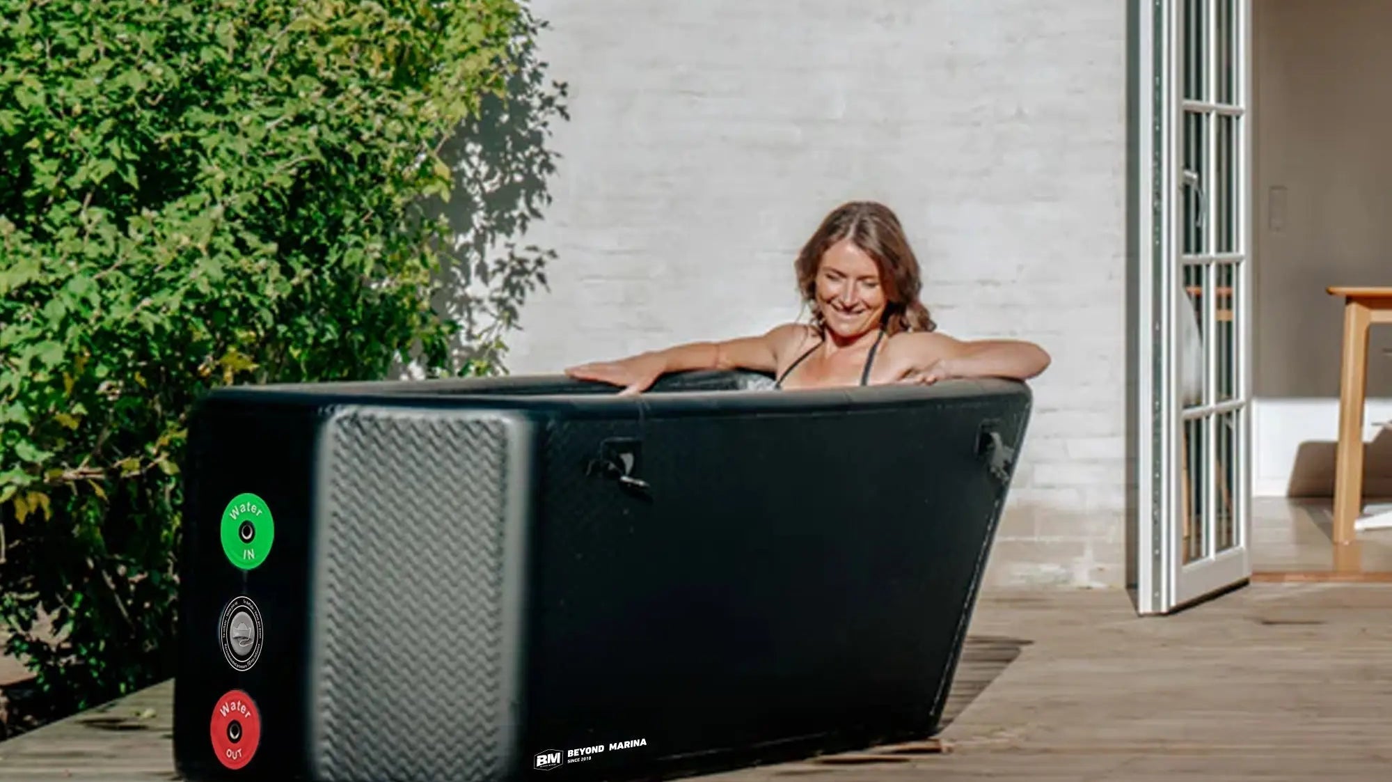 Inflatable black cold plunge tub with control panel for recovery in marina slanted-edge cold plunge