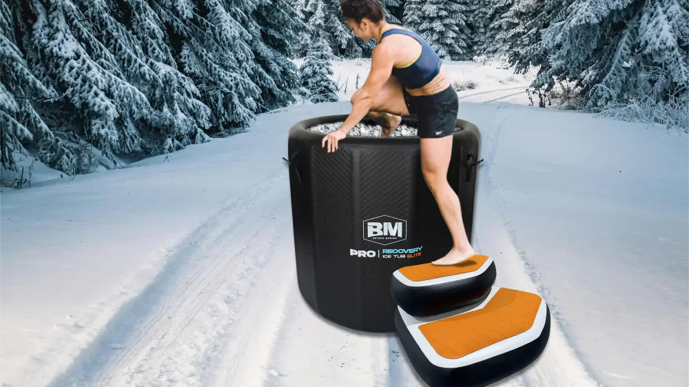 Black inflatable ice bath with orange-topped non-slip steps for cold plunge sessions