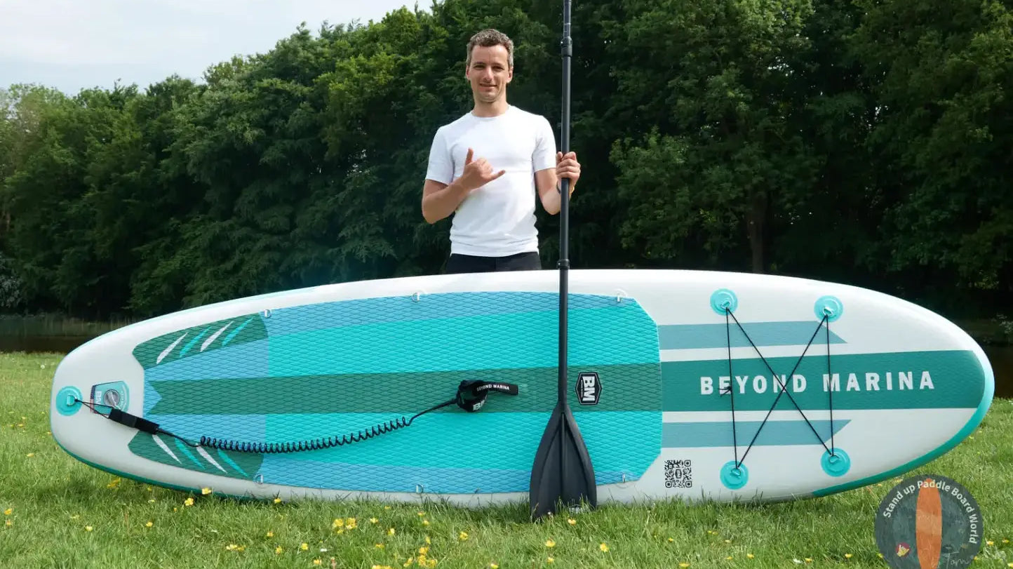Man on a surfboard paddleboarding in serene lakes for water adventures beyond Marina.