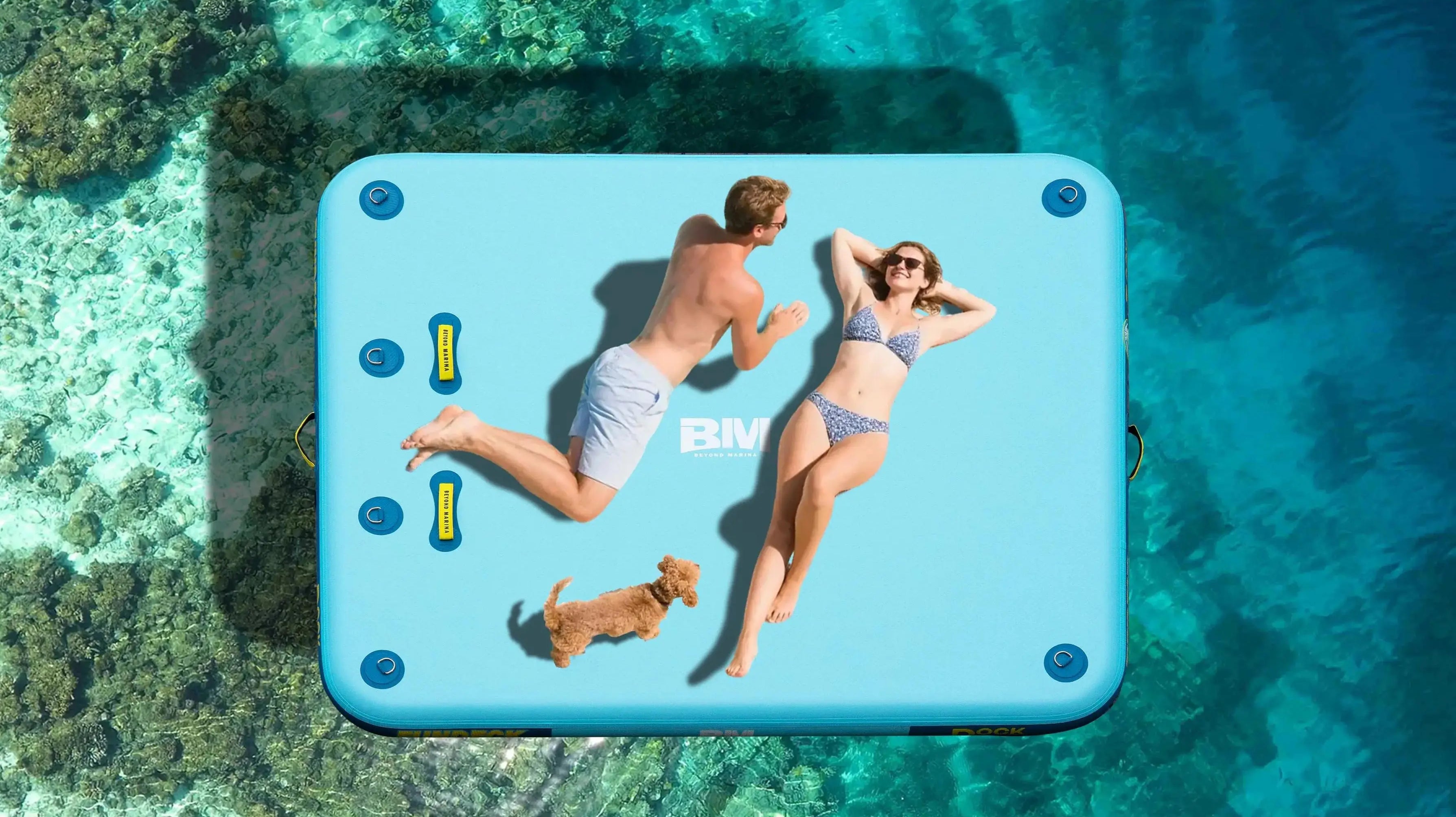 A man, a woman, and a dog sunbathing on a floating dock.