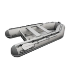 Inflatable gray dinghy boat with oars, ideal for fishing and relaxing at the marina