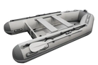 Inflatable gray dinghy boat with oars, ideal for fishing and relaxing at the marina