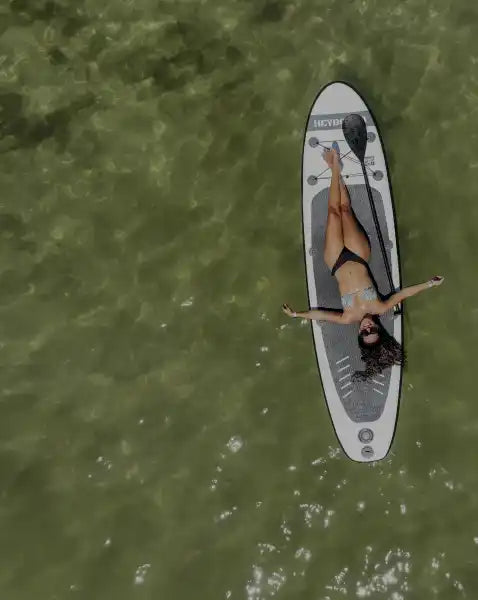 Paddleboard with reclining woman.