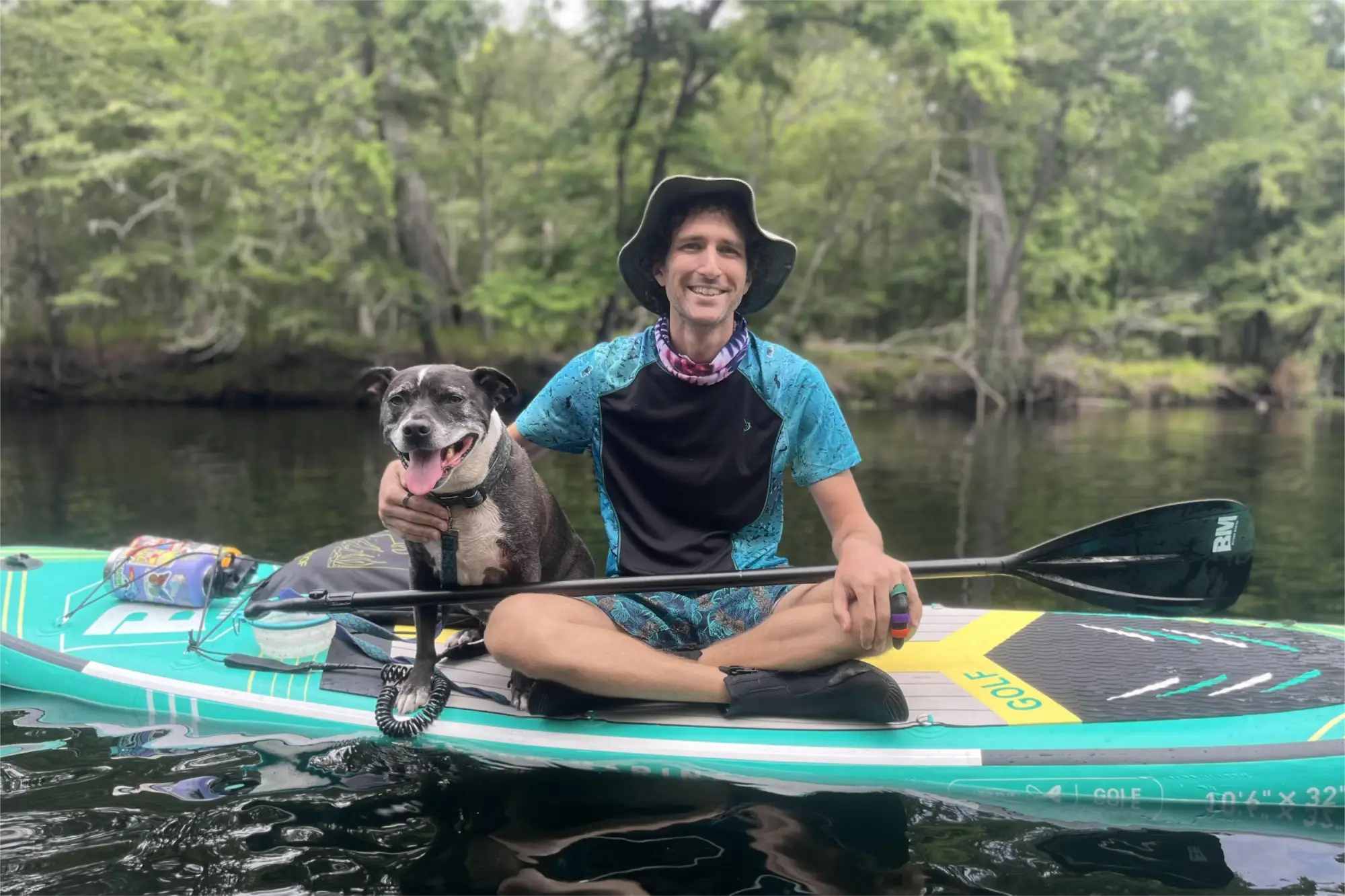Paddleboard with man and dog illustrating paddleboarding tips and blade angle correction