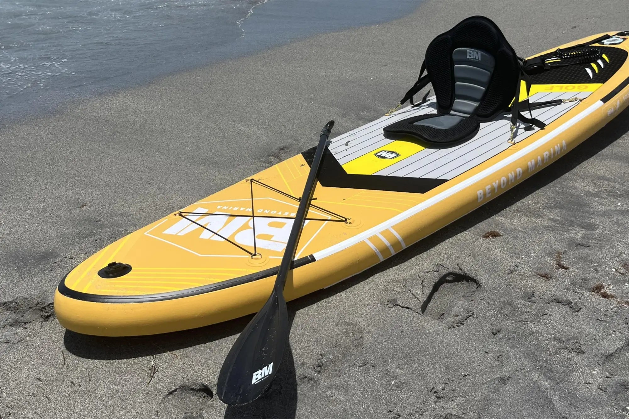 Yellow stand-up paddleboard with seat and paddle for water adventures, shown in SUP care article