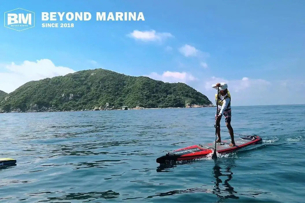 Person paddleboarding on an inflatable paddle board at Marina Race Uno