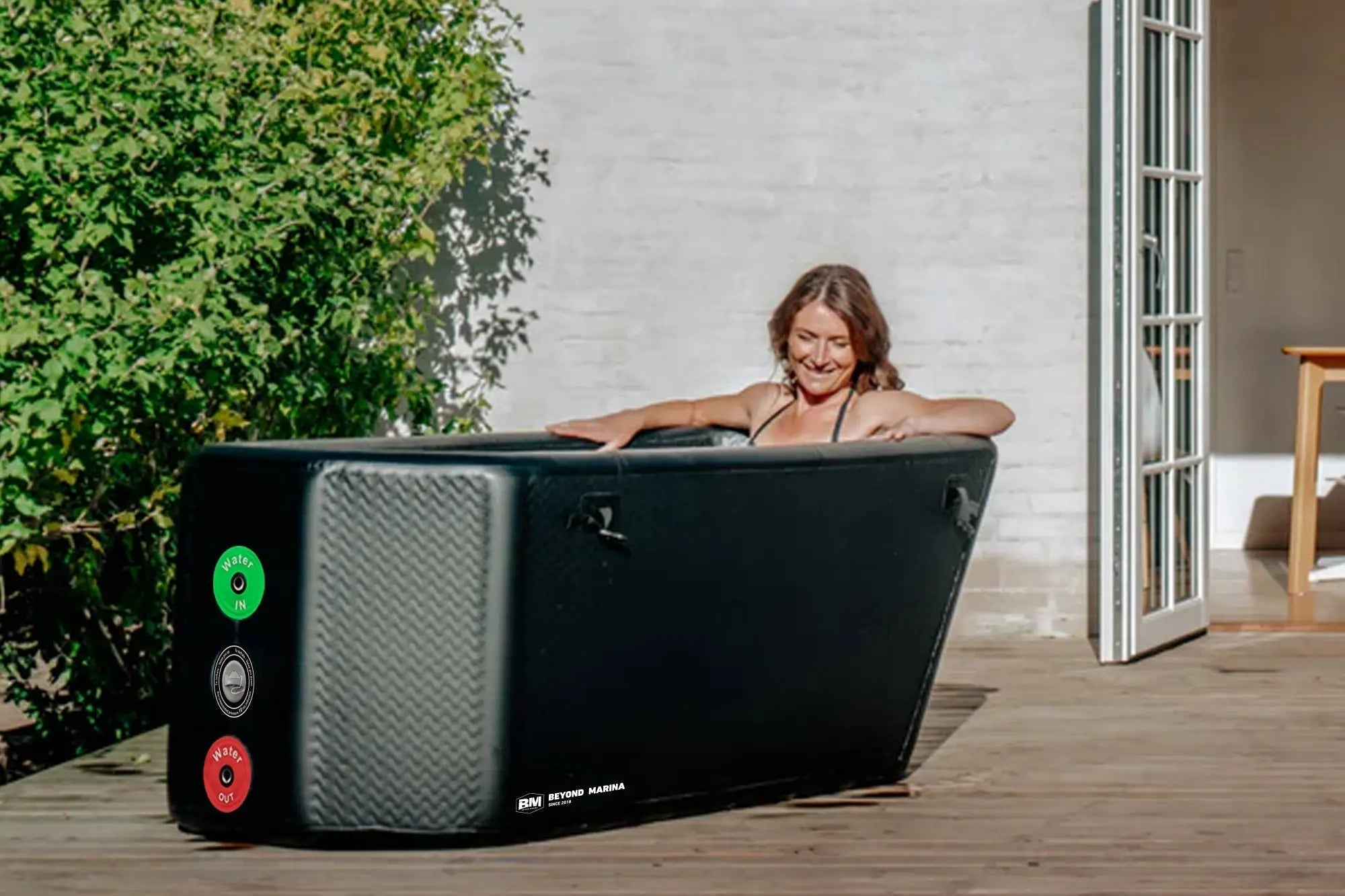 Inflatable black cold plunge tub with control panel for recovery in marina slanted-edge cold plunge