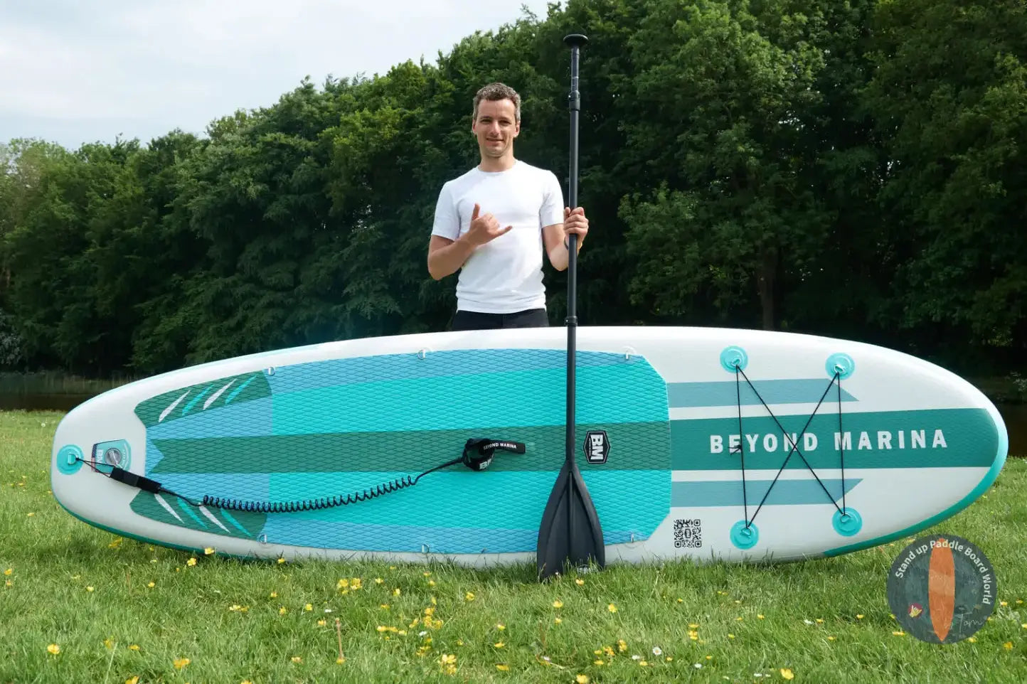 Man on a surfboard paddleboarding in serene lakes for water adventures beyond Marina.