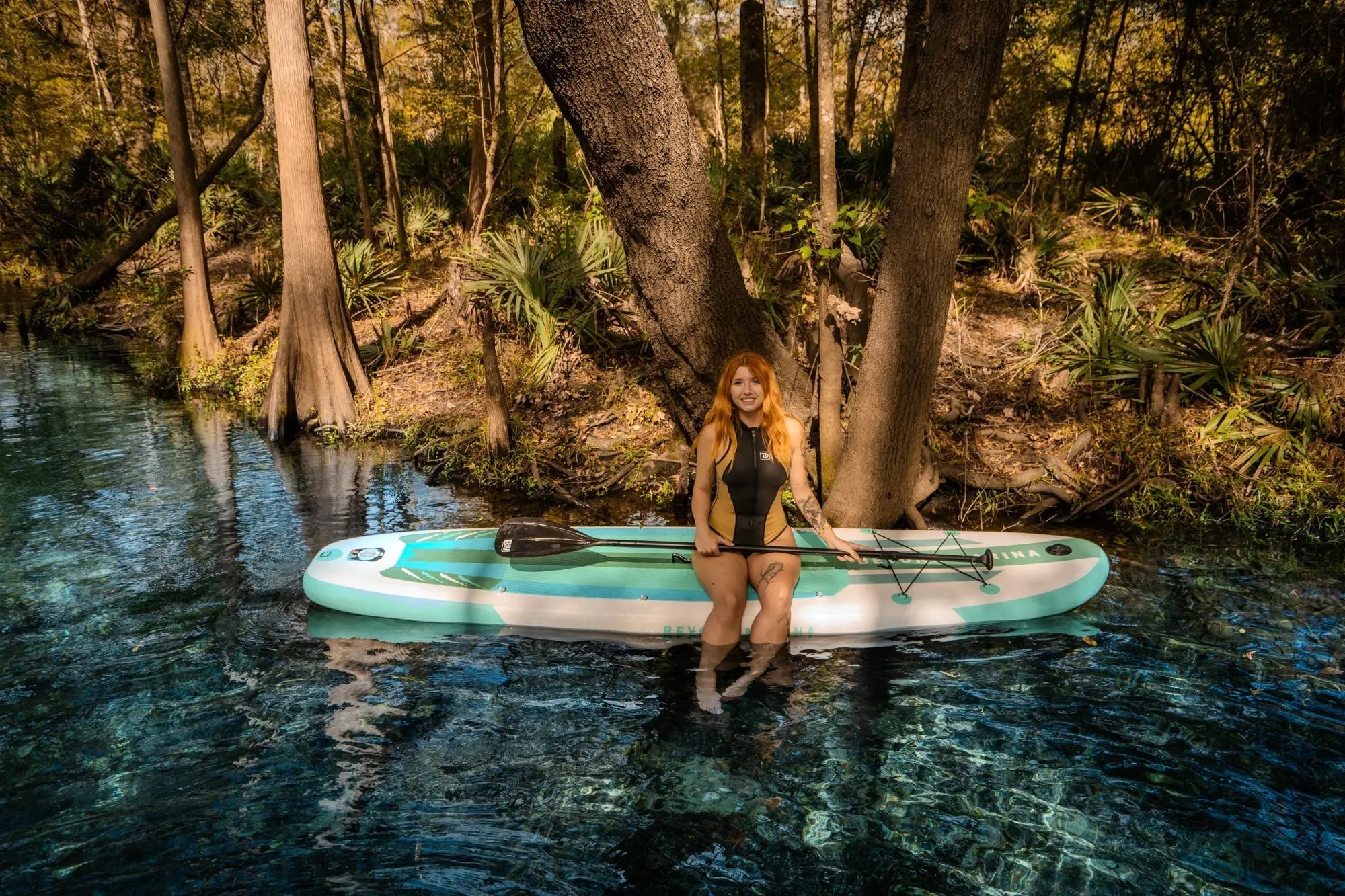 Paddleboard featuring drop stitch material and non-slip EVA surface for marina adventures