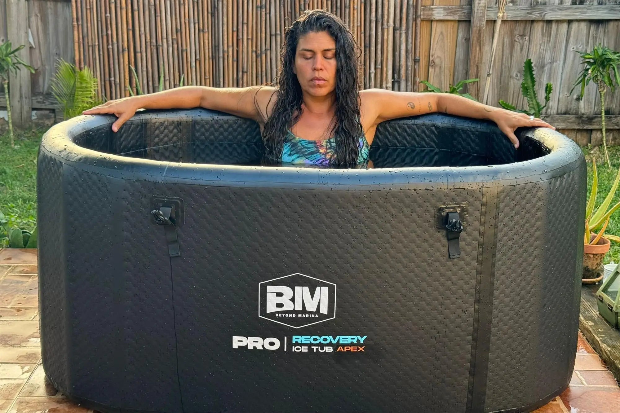 Woman relaxing in an inflatable ice tub showcasing the Marina Drop Stitch design.