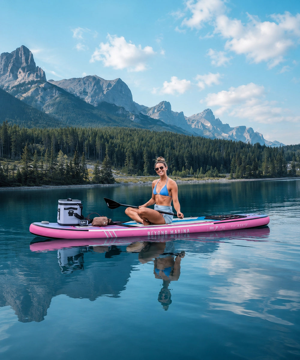 Woman on an inflatable pink paddle board on a lake