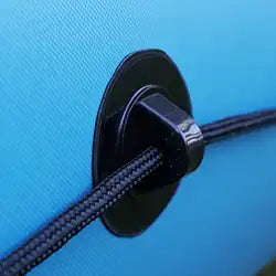Black cord guide on blue fabric.