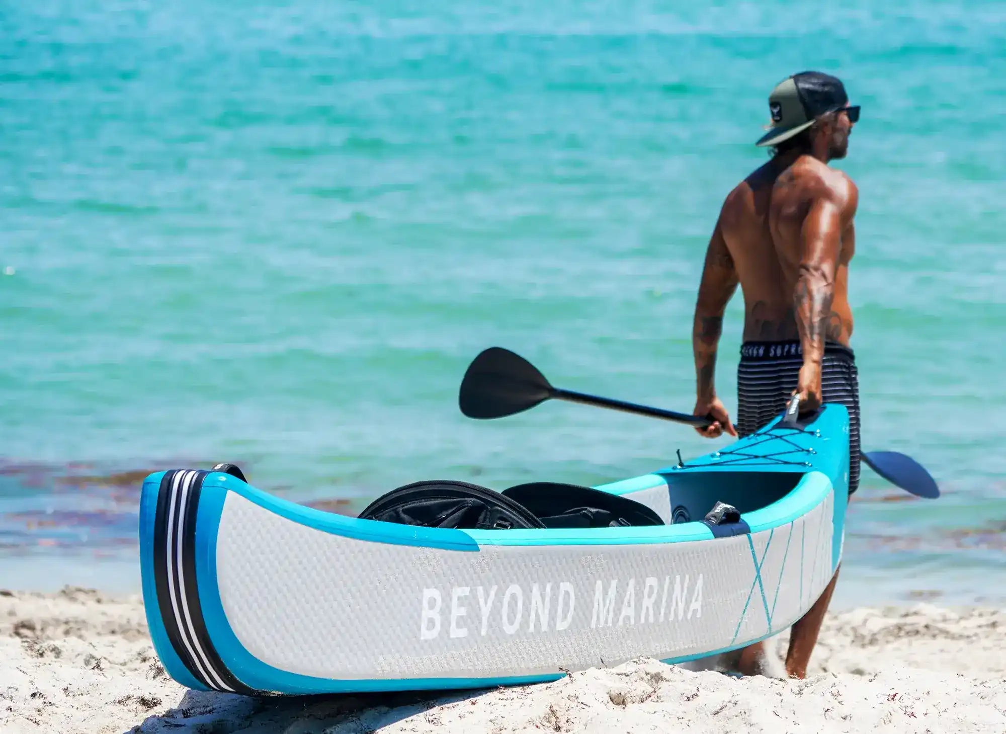 Inflatable kayak with paddle.