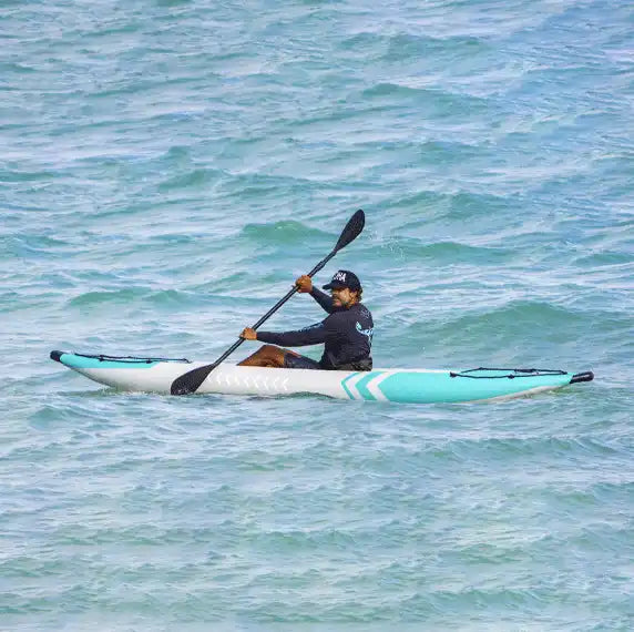 Man paddling a kayak.