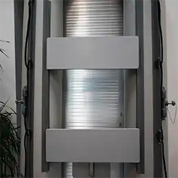 Silver metal rolling shutter mechanism.