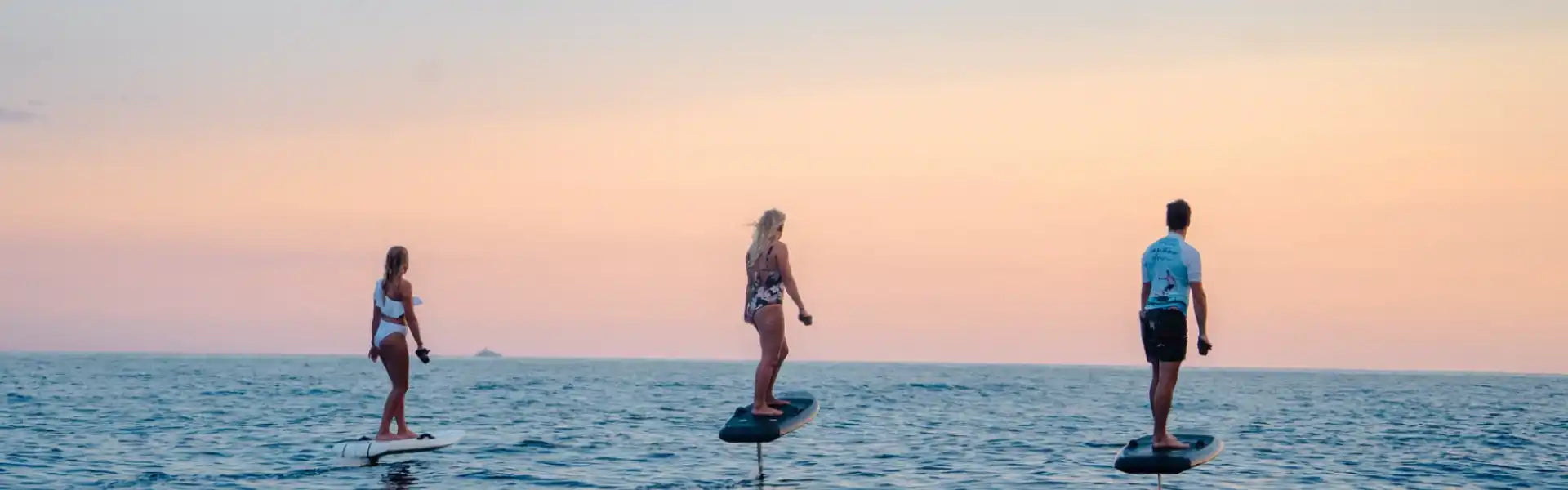 Three people hydrofoiling.