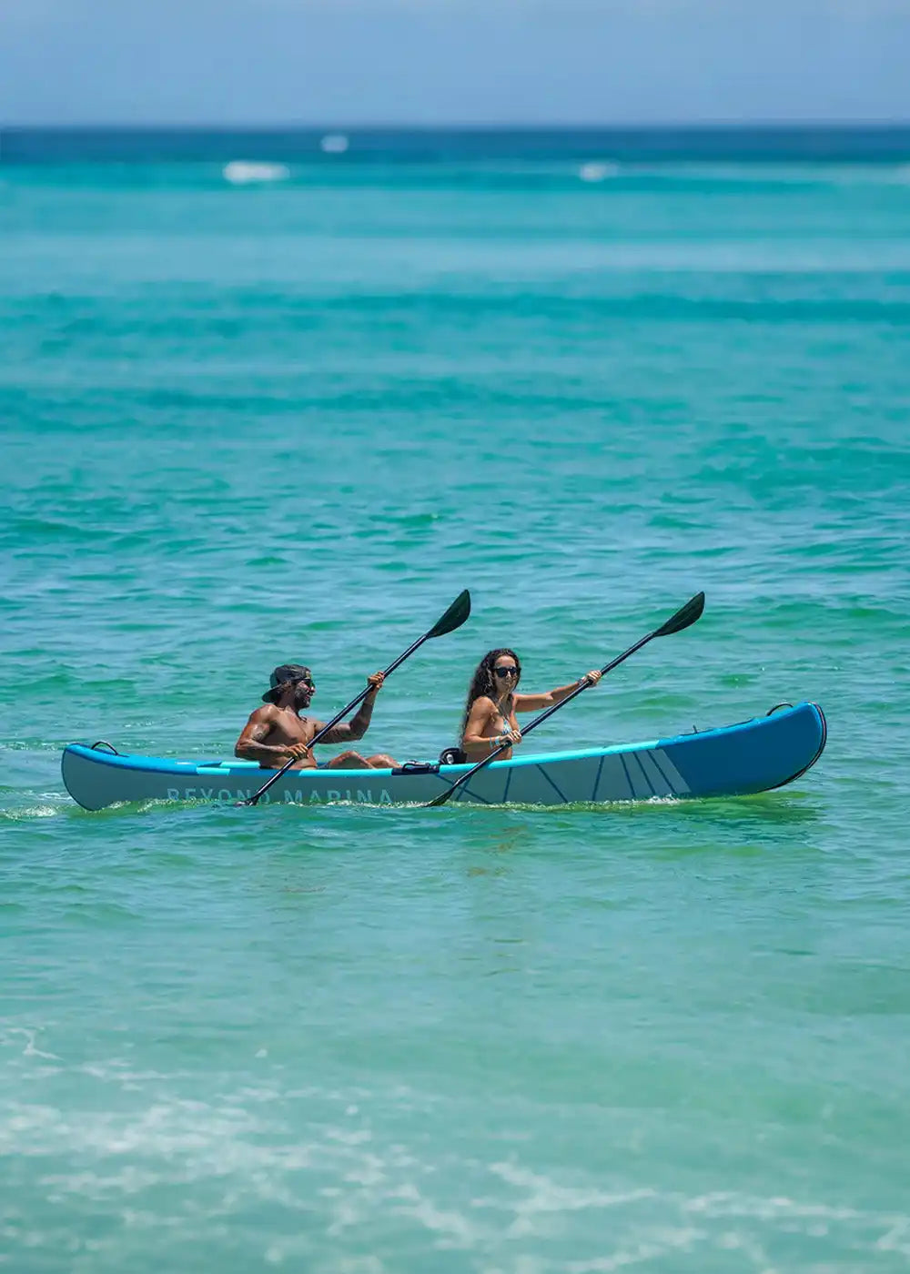 Two-person kayak with paddles.